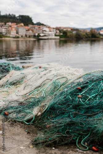 Fishing nets on shore in town photo