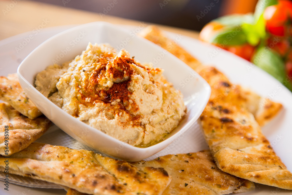 Hummus is a cream of chickpeas cooked with lemon juice, which includes tahini paste and olive oil, which, depending on the local variant, can also include other ingredients such as garlic or paprika.