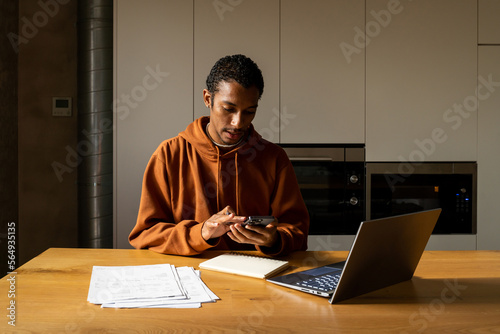 Man paying utility bills from home calculating expenses