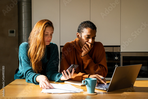 Room-mates paying utility bills at home
