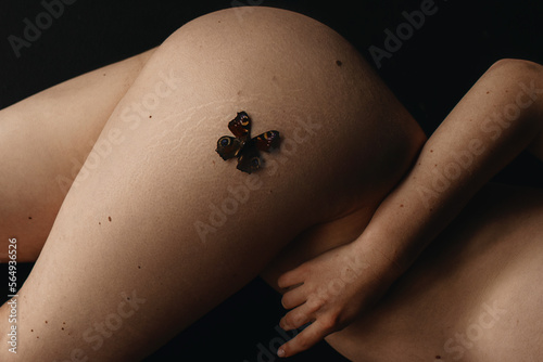 Photo of the woman's skin texture of hip and butterfly photo