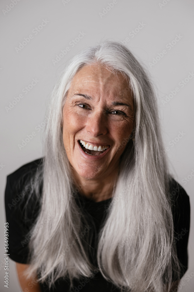 Cheerful elderly woman with gray hair in studio Cheerful elderly woman with gray hair in studio
