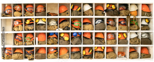 Tablou pe pânză Old and worn-out construction helmets and ear protectors against loud sounds
