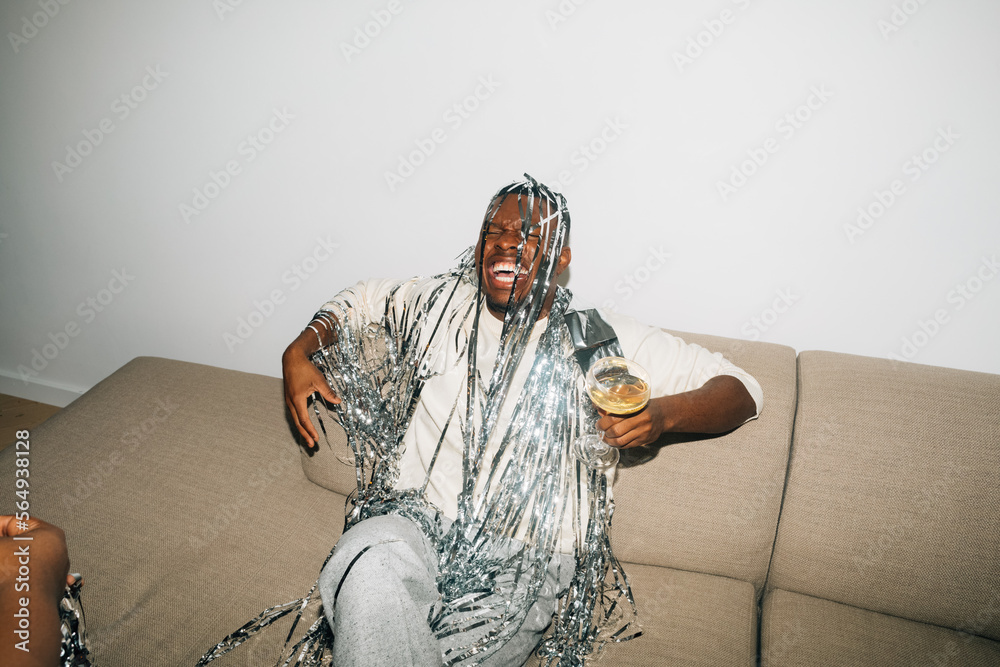 © Studio Firma/Stocksy - Man Drinking Champagne and Laughing