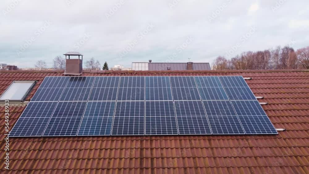 Aerial dolly in towards set of solar panels installed on the roof of big modern house Aerial dolly in towards set of solar panels installed on the roof of big modern house