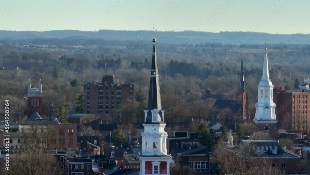 Aerial zoom of three church steeples in American city during winter. Religion in America theme. Aerial zoom of three church steeples in American city during winter. Religion in America theme.