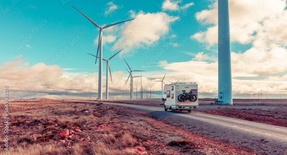 Motorhome near wind turbines eolic renewable energy - obrazy, fototapety, plakaty 