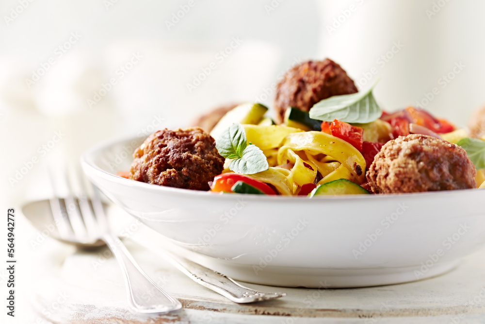 Pappardelle Pasta with Meatballs and fresh Basil on bright background. Close up. Pappardelle Pasta with Meatballs and fresh Basil on bright background. Close up.