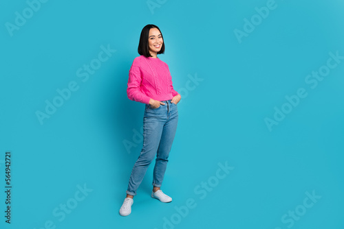 Full body portrait of stunning satisfied lady put arms pockets empty space isolated on blue color background