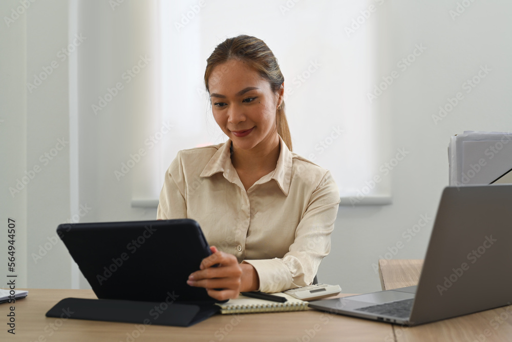 Gorgeous female entrepreneur using laptop computer, working online sale marketing at modern workplace Gorgeous female entrepreneur using laptop computer, working online sale marketing at modern workplace