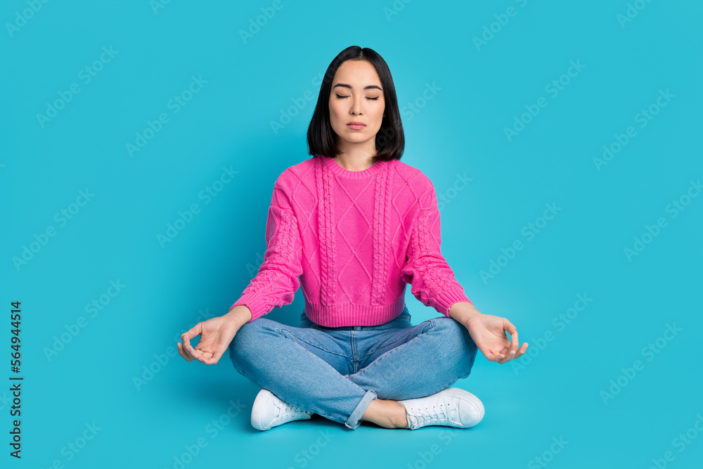 Full length photo of cute adorable lady wear pink pullover closed eyes enjoying yoga isolated blue color background Full length photo of cute adorable lady wear pink pullover closed eyes enjoying yoga isolated blue color background