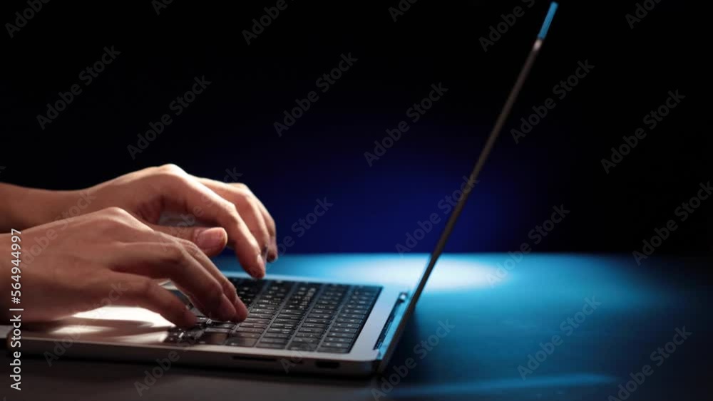 closeup of hands typing codes at late night