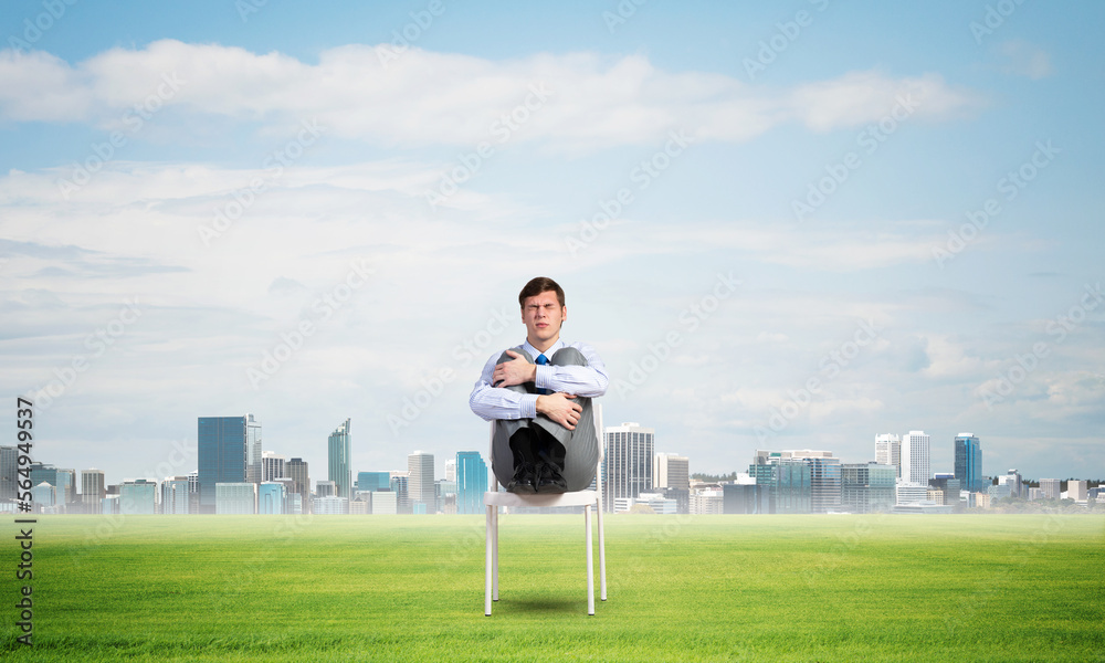 Fototapeta premium scared businessman on a chair