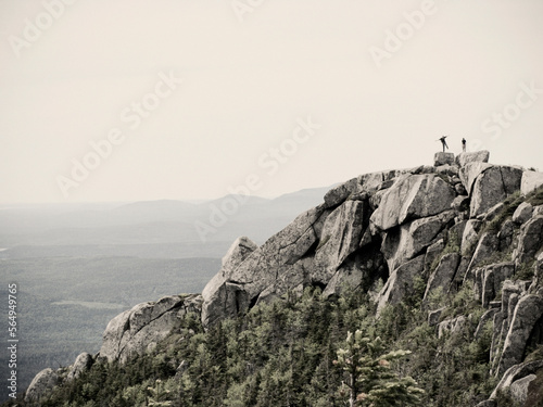 Hikers pose on the rocky summit of Doubletop Mountain in Maine's Baxter State Park.