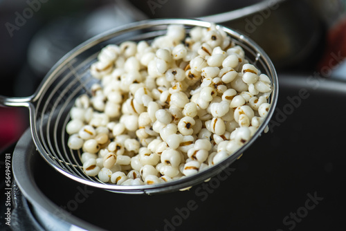 Hot Boiled Job’s Tears millet seed from boiler. White boiled Job’s Tears is highly nutritious cereal healthy fresh organic in salad dish.