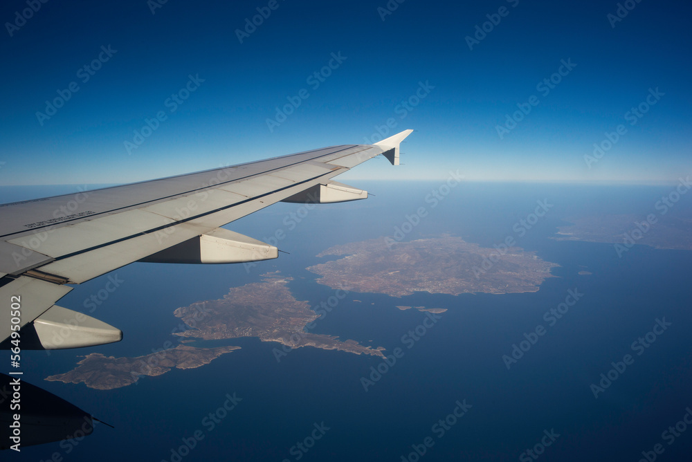 A plane flying over an island. A plane flying over an island.