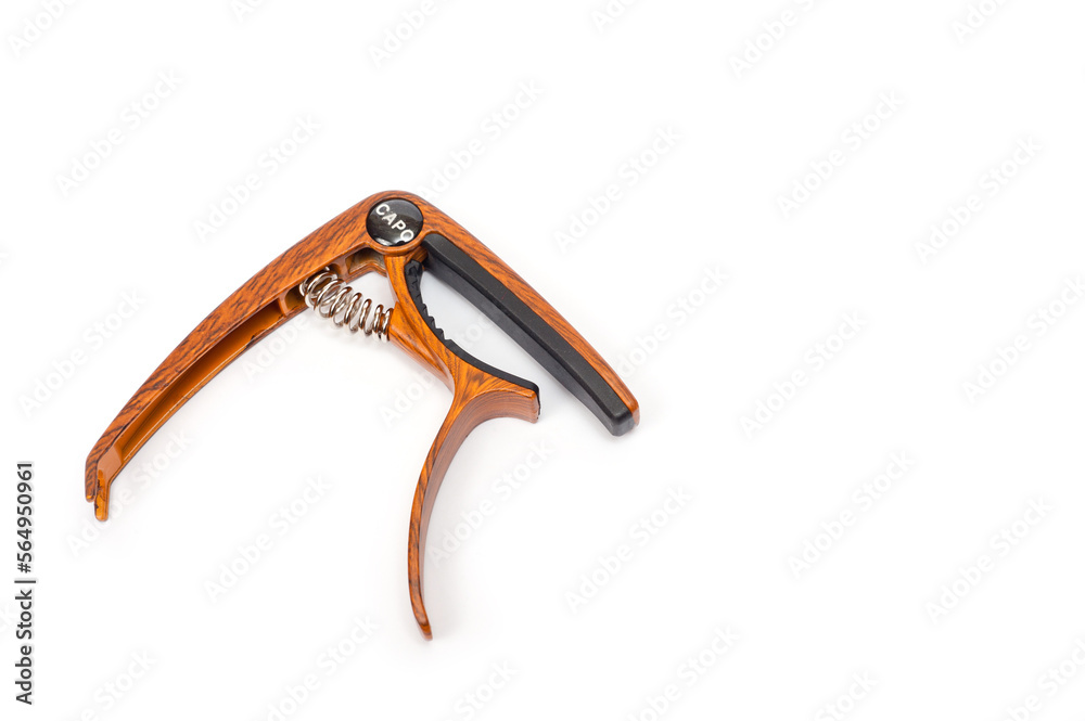 Metal capo for guitar with spring painted wood. Metal capo for guitar with spring painted wood.