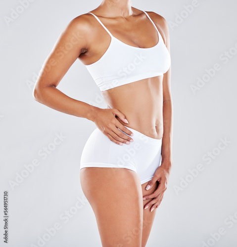 Fitness, wellness and body of woman in studio after workout, exercise and training to lose weight. Self care, skincare and abdomen of female model for nutrition, diet routine and healthy lifestyle © Wesley JvR/peopleimages.com