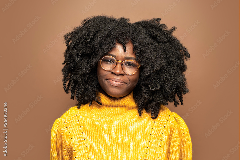 Confident black woman with curly hair looking at camera Confident black woman with curly hair looking at camera