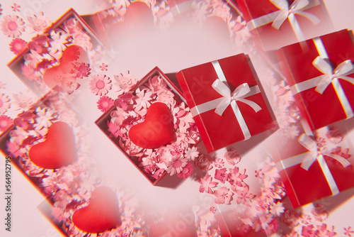Open gift box with a cute little heart inside on pink background