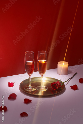Champagne or wine in elegant glasses on a pink background 