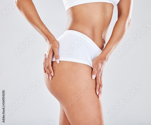 Cellulite, skincare and body of woman for fitness, slimming treatment and liposuction on white background. Wellness, beauty and legs of girl model for nutrition, diet and healthy lifestyle in studio
