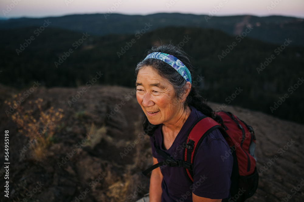 Woman sitting on hilltop watching sunrise. Woman sitting on hilltop watching sunrise.