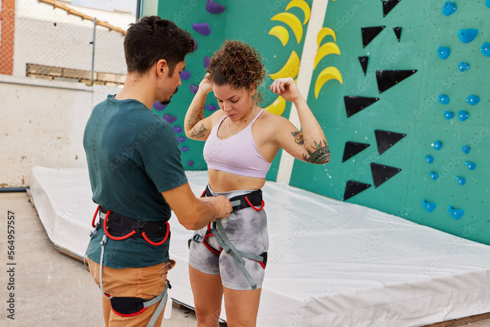 Young climbers adjusting harness Young climbers adjusting harness