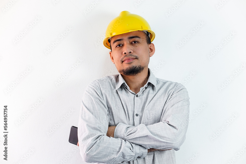 Asian manager civil engineer in uniform hard hat holding clipboard working in studio isolated white background.
