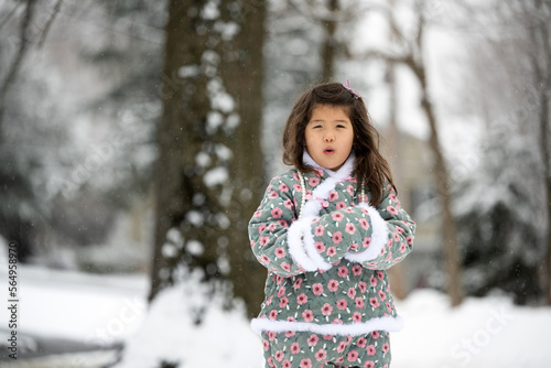 Little kid bundled up in the snow