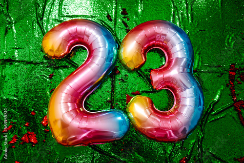 number 23 on a green sequin fabric photo