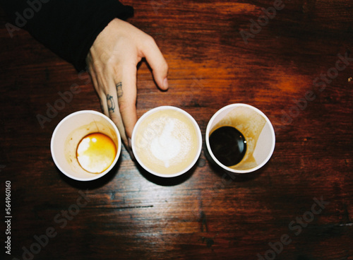Man's hand with coffee cups