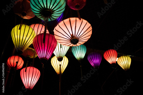 Low angle view of illuminated colorful lanterns in darkroom photo