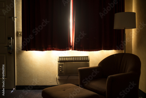 Furniture by old-fashioned air conditioner in room at home photo