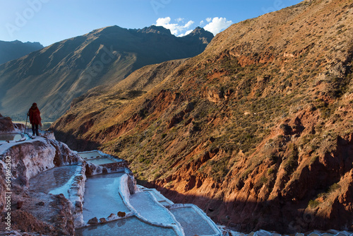 A woman stands on the edge of salt pools used today and by the Incas centuries ago near the tiny village of Maras.
