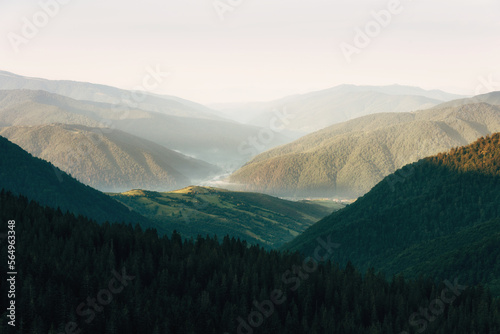 Wonderful  landscape in the mountains at sunrise. View of a scenic  forest hills. Golden Hour morning light. Effect warm natural light.