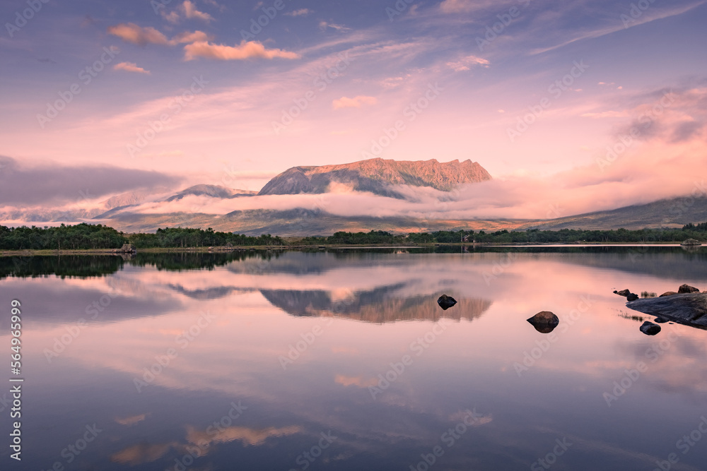 Fototapeta premium Spectacular reflection of the mountains on a lake with mist under the midnight sun, fairy tale atmosphere in the Vesteralen Islands, Norway