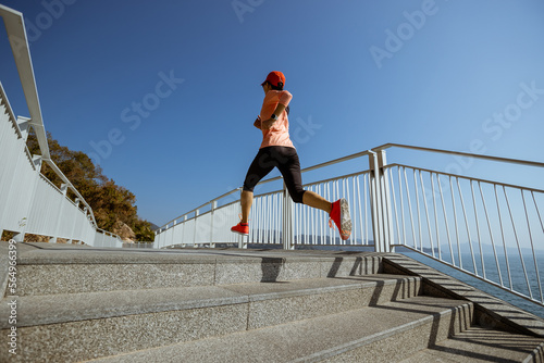 Healthy lifestyle fitness sports woman runner running on seaside trail © lzf