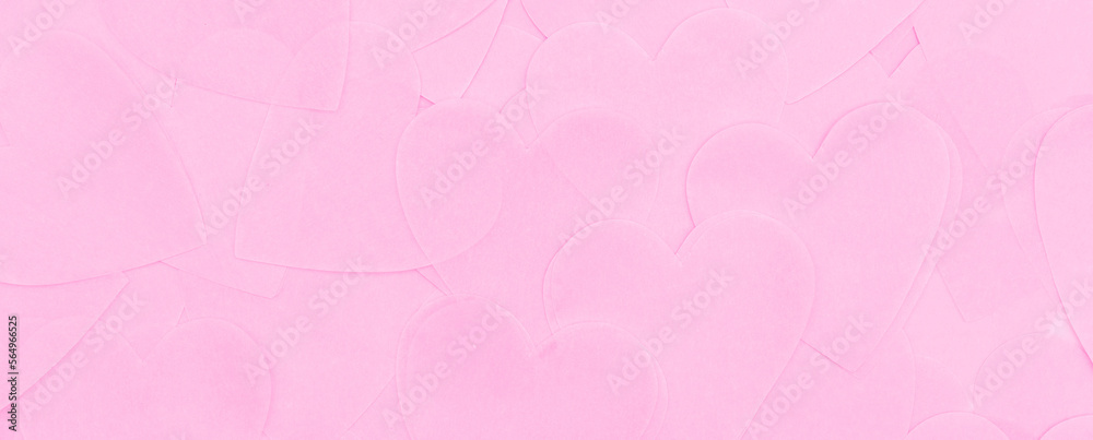 Romantic background banner made of pink paper hearts. Delicate background of thin pink tracing paper in the shape of hearts. Pink background made of hearts with copy space for Valentine's Day.
