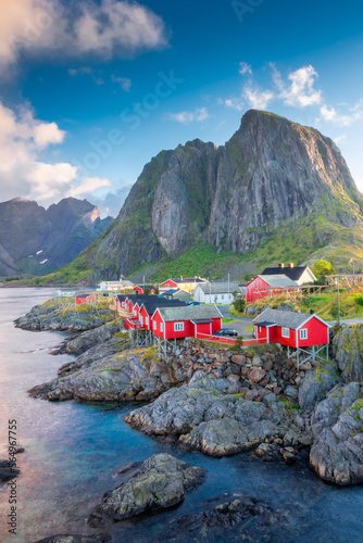Beautiful sunrise over Hamnoy, fishermen village with the typical red houses of the Lofoten Islands , Norway