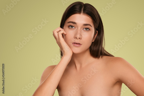 Young woman with perfect skin looking at camera