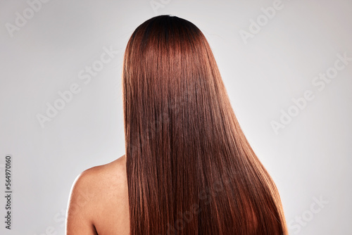 Hair care, health and beauty of girl with texture shine and smooth keratin style of people. Glossy aesthetic and glow treatment of person back view at isolated studio gray background.