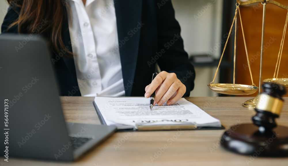 justice and law concept. asian woman lawyer working and judge in a courtroom the gavel, working with tablet and laptop and digital tablet computer justice and law concept. asian woman lawyer working and judge in a courtroom the gavel, working with tablet and laptop and digital tablet computer