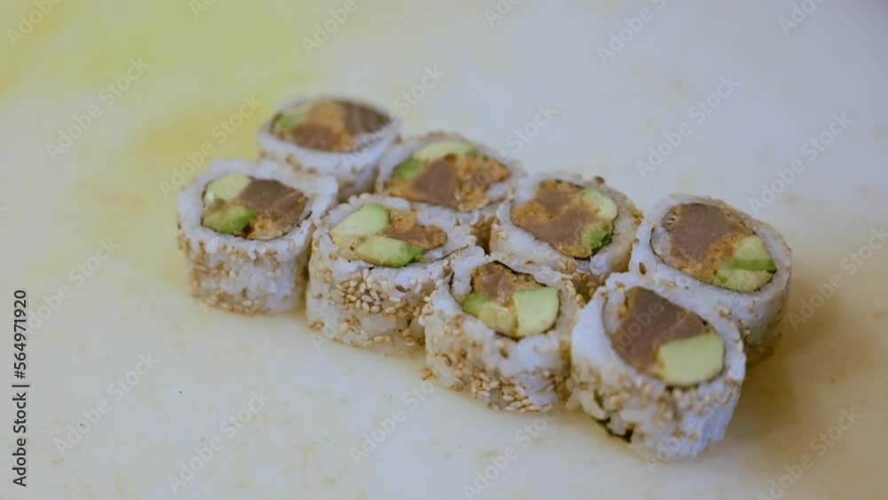 Person Wearing Gloves Placing Fresh Sushi Slices Side By Side Person Wearing Gloves Placing Fresh Sushi Slices Side By Side