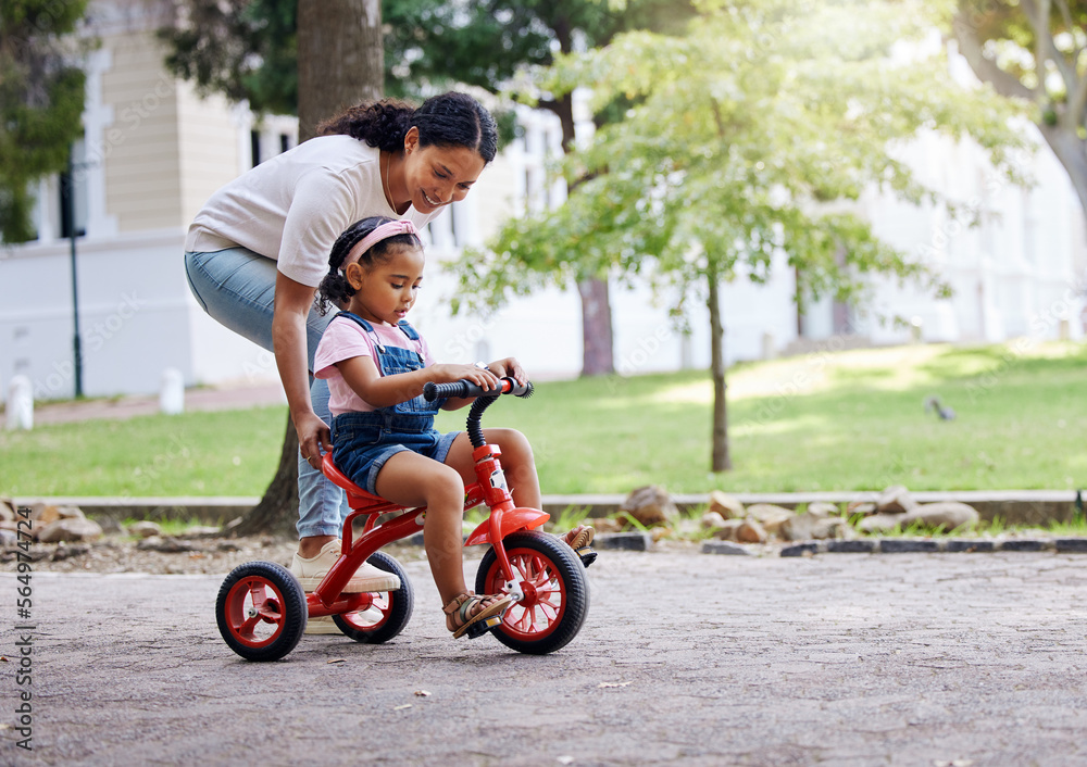 Mother teaching child, bike and learning in park, outdoor with growth and development, family and care. Nature, learn to ride tricycle with woman and girl, childhood and parenting with happy female Mother teaching child, bike and learning in park, outdoor with growth and development, family and care. Nature, learn to ride tricycle with woman and girl, childhood and parenting with happy female