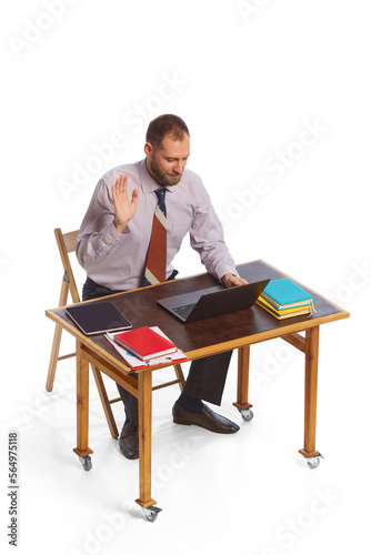 Wallpaper Mural Young thoughtful business man dressed in casual office style clothes sitting at table and working isolated on white background. Business, work, career concept Torontodigital.ca