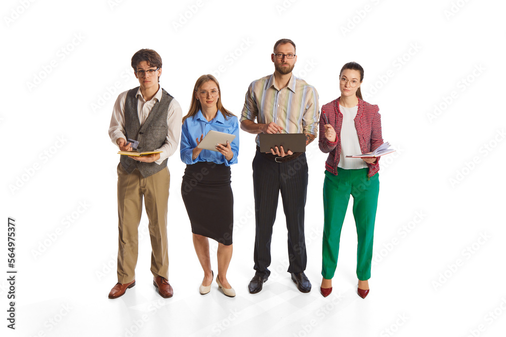 Group of young people, businessmen, office workers standing together and looking at camera isolated over white background.