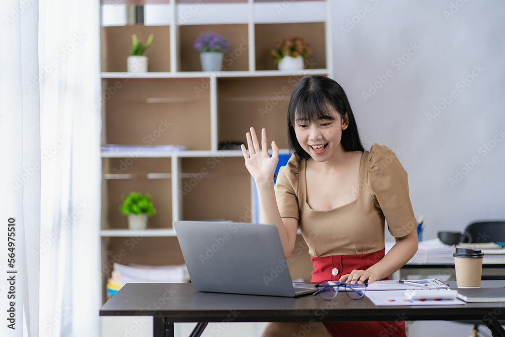 Happy asian businesswoman waving to partner during video conference with team enjoying online communication at home Woman using wifi while video conference with friends sitting in front of laptop Happy asian businesswoman waving to partner during video conference with team enjoying online communication at home Woman using wifi while video conference with friends sitting in front of laptop
