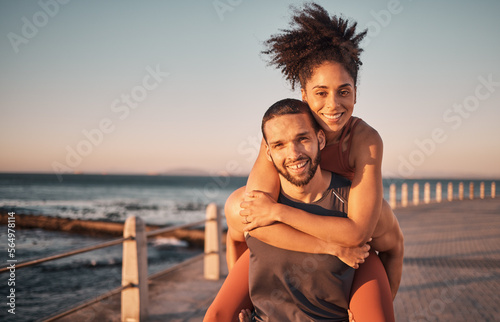 Fitness, beach and portrait of couple piggyback enjoy holiday, vacation and quality time on weekend. Love, summer and black man and woman relax after running, exercise workout and training by ocean