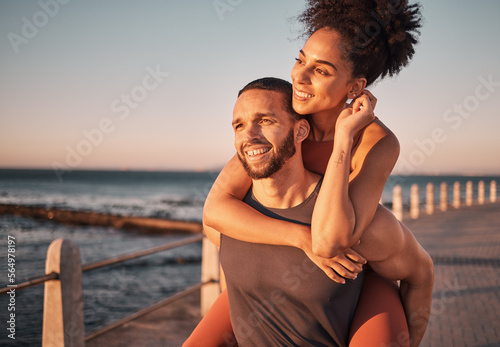 Beach, sunset and couple piggyback in summer enjoying holiday, vacation and quality time on weekend. Love, dating and black man and woman relax after running, fitness workout and training by ocean